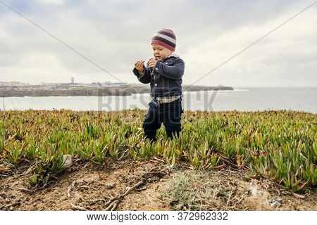 Toddler Exploring Nature On Beautiful Coast Of Papoa Islet In Peniche, Leiria District, Portugal