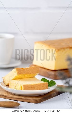 Plain Classic Taiwanese Traditional Sponge Cake (taiwanese Castella Kasutera) On A Wooden Tray Backg