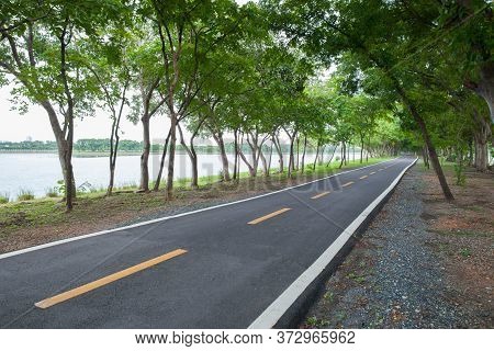 Empthy Running Lanes Of Road In Park Between Tree At Sunset Timing Location At Bangkok Thailand