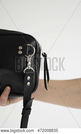 Details Of Leather Black Handmade Bag Over His Shoulder. Dark Designer Banana Bagon A White Backgrou