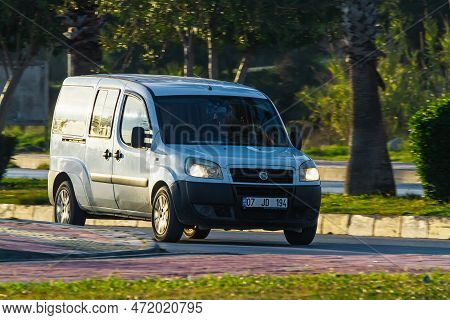 Side, Turkey -  January 31 2022:   Blue Fiat Doblo  Is Driving Fast On The Street On A Warm Summer D