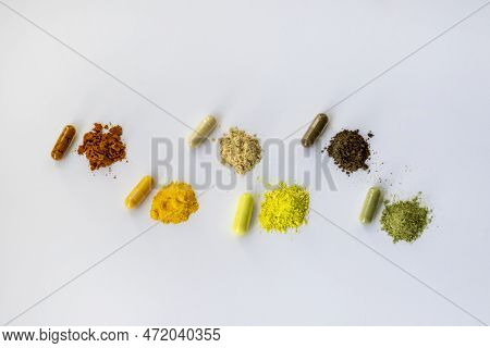 Opened And Whole Capsules Of Dietary Supplements On A White Background. Various Tablets And Vitamins