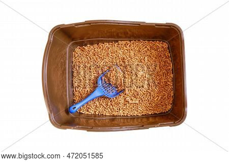 Brown Toilet Tray For Cat With Wood Pellets And Scoop, Isolated On A White Background. The Cats Toil