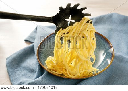 Serving Fresh Pasta, Spaghetti Are Filled Onto A Blue Plate With A Special Spoon, Napkin On A Light 