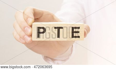 Wooden Cubes With The Letters Pte On The Hand On The White Background. Qa Is Short For Question And 