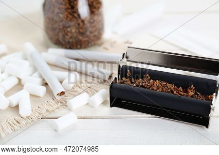 Hand Rolled Cigarettes, Filters And Tobacco On White Wooden Table, Closeup