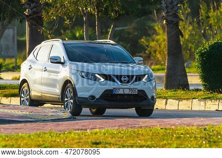 Side, Turkey -january 27, 2023:  White  Nissan Qashqai  Is Parking Fast On The Street On A Warmn Day