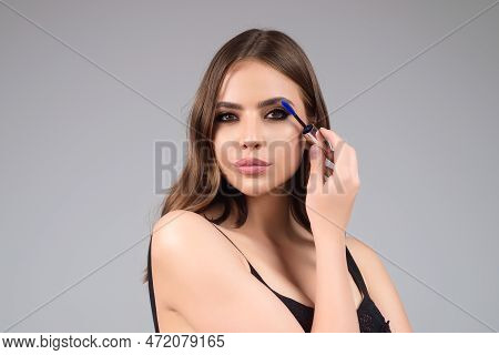 Beautiful Woman With Dark Eyebrows Hold Eyebrow Brush. Eyebrows Lamination. Brow Beauty Procedures. 