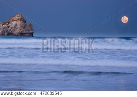 Full Blue Moon Rising Over The Lagoon At Sunset At The Castlepoint Gap Next To Castle Rock