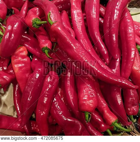 Red Fresh Sweet Peppers Of The Ramiro Variety In A Store Or Market. Vegetable Vegetarian Background