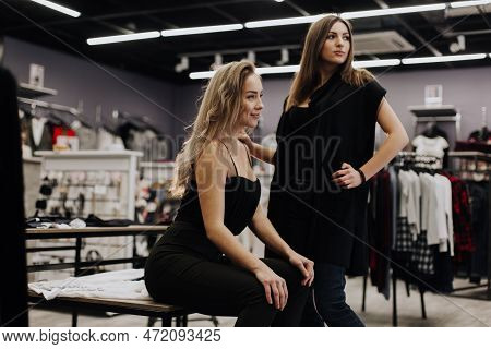 Woman With Dress In The Checkroom. A Clothing Store