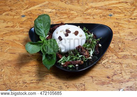 Italian Buratta Salad With Pesto And Arugula And Cherry Tomatoes