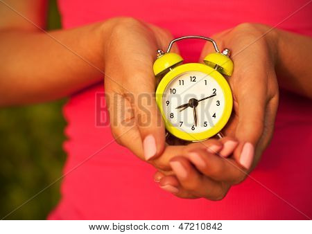 Woman Holding Wecker