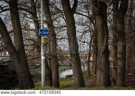 Wroclaw, Poland - February 26, 2023: Sleza River And A Sign Board Along Ostrowskiego Street.