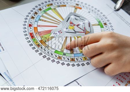 Tver, Russia - February 12, 2023: A Woman At The Table Is Studying A Rave Mandala By Human Design. R