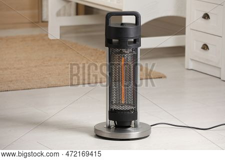 Modern Infrared Heater On Floor In Cozy Room. Space For Text