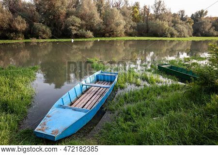 Panorama Of An Abandoned Rowing Boat, An Blue Small Boat, Resting In The Neglected Shore Of The Tami