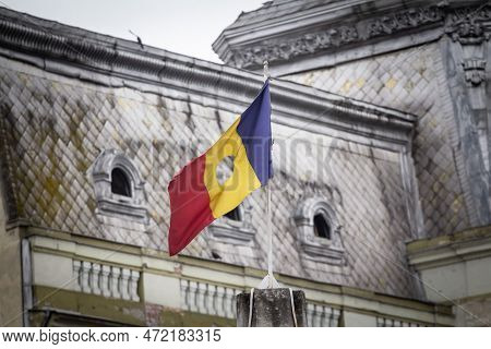 Romanian Revolutionary Flag With A Hole, Also Called Drapelul Romaniei Waiving On A Flagpole Of Timi