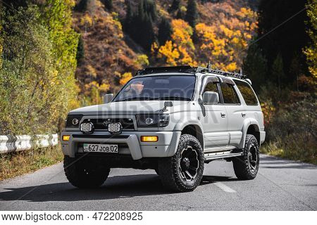 Off-road White 4x4 Car Toyota 4runner On Autumn Mountain Road Trip