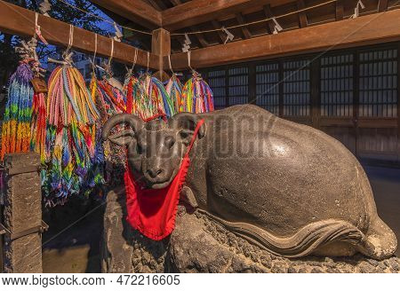 Tokyo, Japan - March 25 2023: Garlands Of A One Thousand Origami Cranes And Stone Statue Of A Nadeus