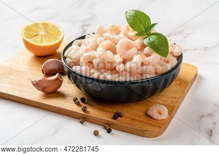 Frosen Shrimps In A Bowl Prepared For Cooking. Boiled Peeled Prawn Tails, Lemon, Garlic And Pepper O