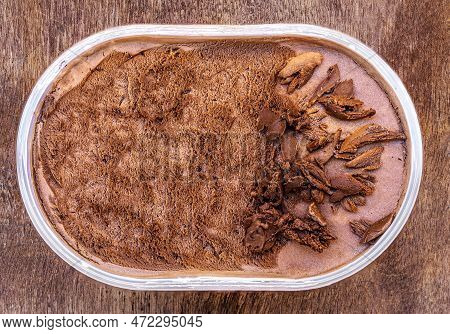 Chocolate Icecream On A Wooden Rustic Background. Dark Chocolate  Ice Cream In A Conteiner