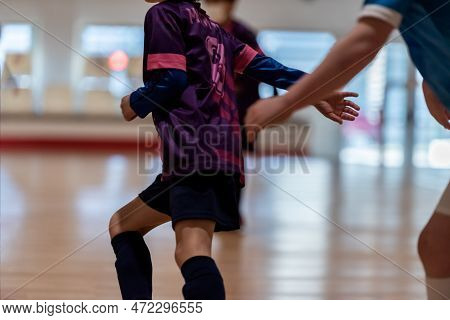 A Player Escapes Her Opponents Dribble In Soccer Game.
