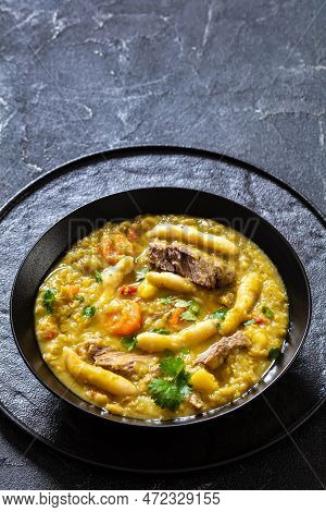 Gungo Peas, Pigeon Peas Soup With Dumplings And Beef In Black Bowl On Concrete Table, Jamaican Cuisi