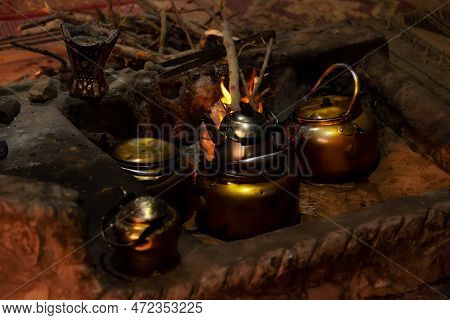 Few Teapots With Bedouin Tea, Kettle On Campfire At Night, Jordan, Wadi Rum