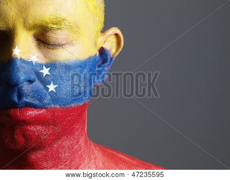 Man's Face Painted With The Flag Of Venezuela And Closed Eyes.