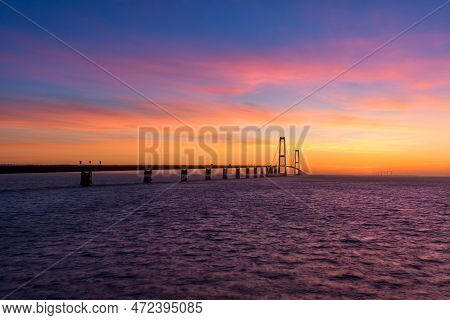 The Great Belt Bridge In Denmark During A Very Colorful Sunset