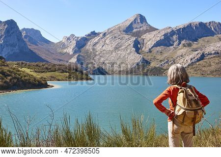 Picturesque Reservoir And Mountain Landscape In Riano. Hiker. Spain