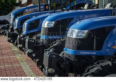 Side , Turkey -  January  27, 2023:    Close-up New Blue Tractors New Holand  Are On Sale In A Car D