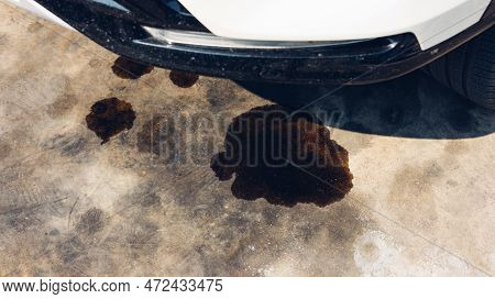 Engine Oil Leakage On Concrete Floor. Black Engine Oil On Concrete Floor. Engine Oil Leak From The E