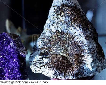 The Astrophyllite Mineral Is Displayed In A Showcase At The Minerals Exhibition