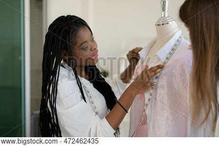 Happy Female Dressmaker Working In Workshop Studio