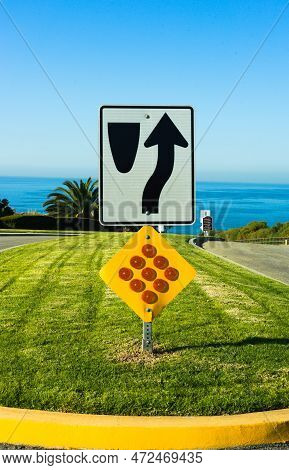 A Divided Road Street Sign Points Up Into A Cloudless Blue Sky. High Quality Photo Featuring Rich Bl