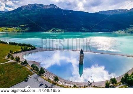 Submerged Bell Tower Of Curon At Graun Im Vinschgau On Lake Reschen Alpine Landscape Aerial View, So