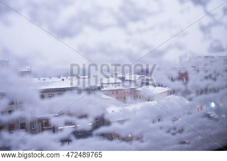 View From A Snow-covered Window On The Roofs Of St. Petersburg