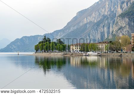 Cloudy Aerial Cityscape Of Lecco Town On Spring Evening. Picturesque Waterfront Of Lecco Town Locate