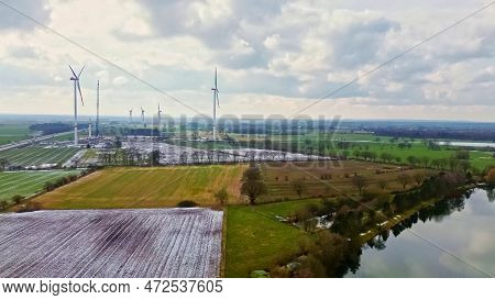 View From Above On The German Motorway A7 With Some Windmills For Renewable Electricity Under Constr