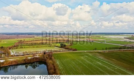 Aerial View Of A Drone On The A7 Motorway In Northern Germany Between Fields And Meadows.