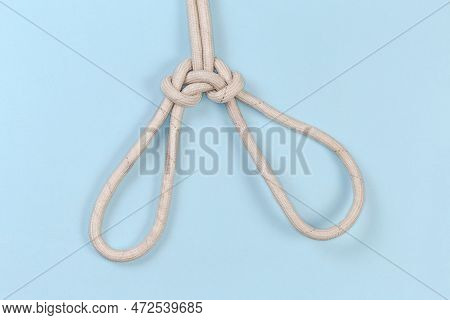 Rope Knot Spanish Bowline Intended To Lift A Person, View From The Front On A Blue Background