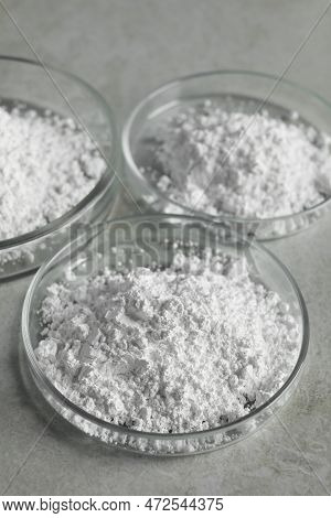 Petri Dishes With Calcium Carbonate Powder On Light Grey Table