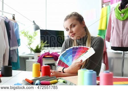 Female Fashion Designer Seamstress Working In Studio Holding Color Palette. Selection And Choice Of 