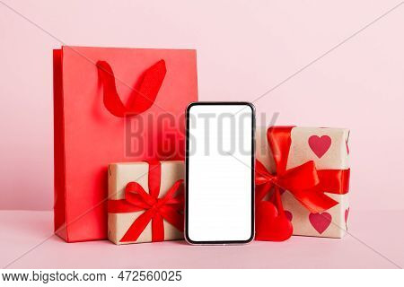Mobile Phone With Blank Screen On Colored Background With Hearts, Calendar And Gift Box, Valentine D