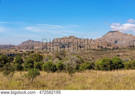 Isalo National Park In Ihorombe Region. Wilderness Landscape With Water Erosion Into Rocky Outcrops,