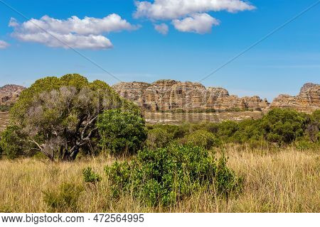 Isalo National Park In Ihorombe Region. Wilderness Landscape With Water Erosion Into Rocky Outcrops,