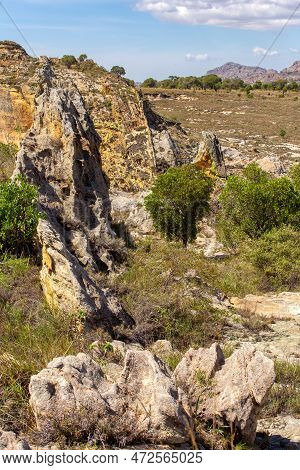 Isalo National Park In Ihorombe Region. Wilderness Landscape With Water Erosion Into Rocky Outcrops,