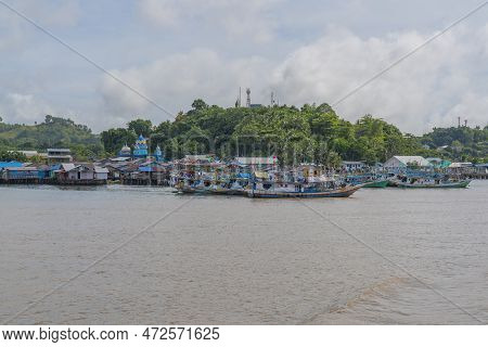View From The Ferry To Waisai At Sorong With Boats And Houses And A Mosque